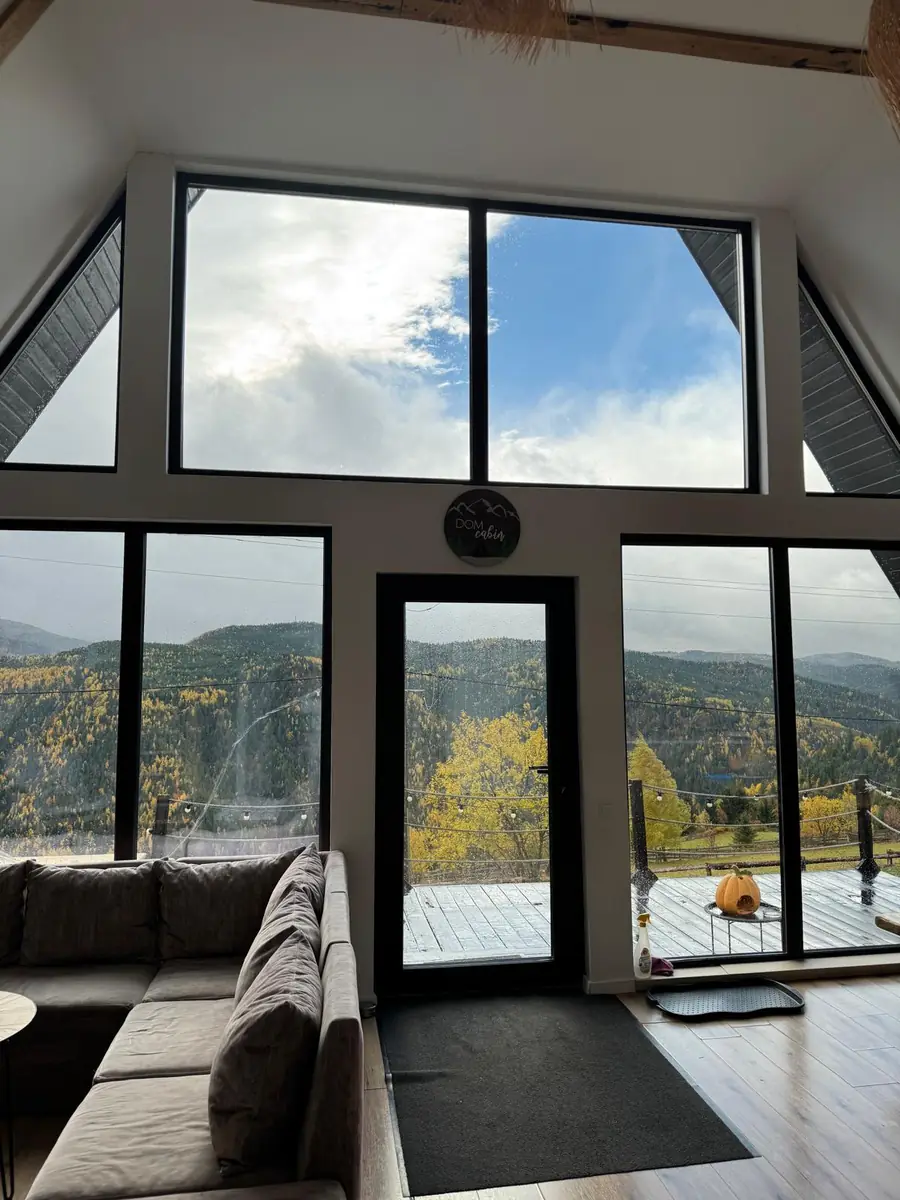 Living room and autumn forest outside